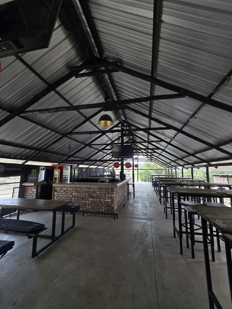 Brick bar counter and high tables inside the covered Oppie Stoep hall