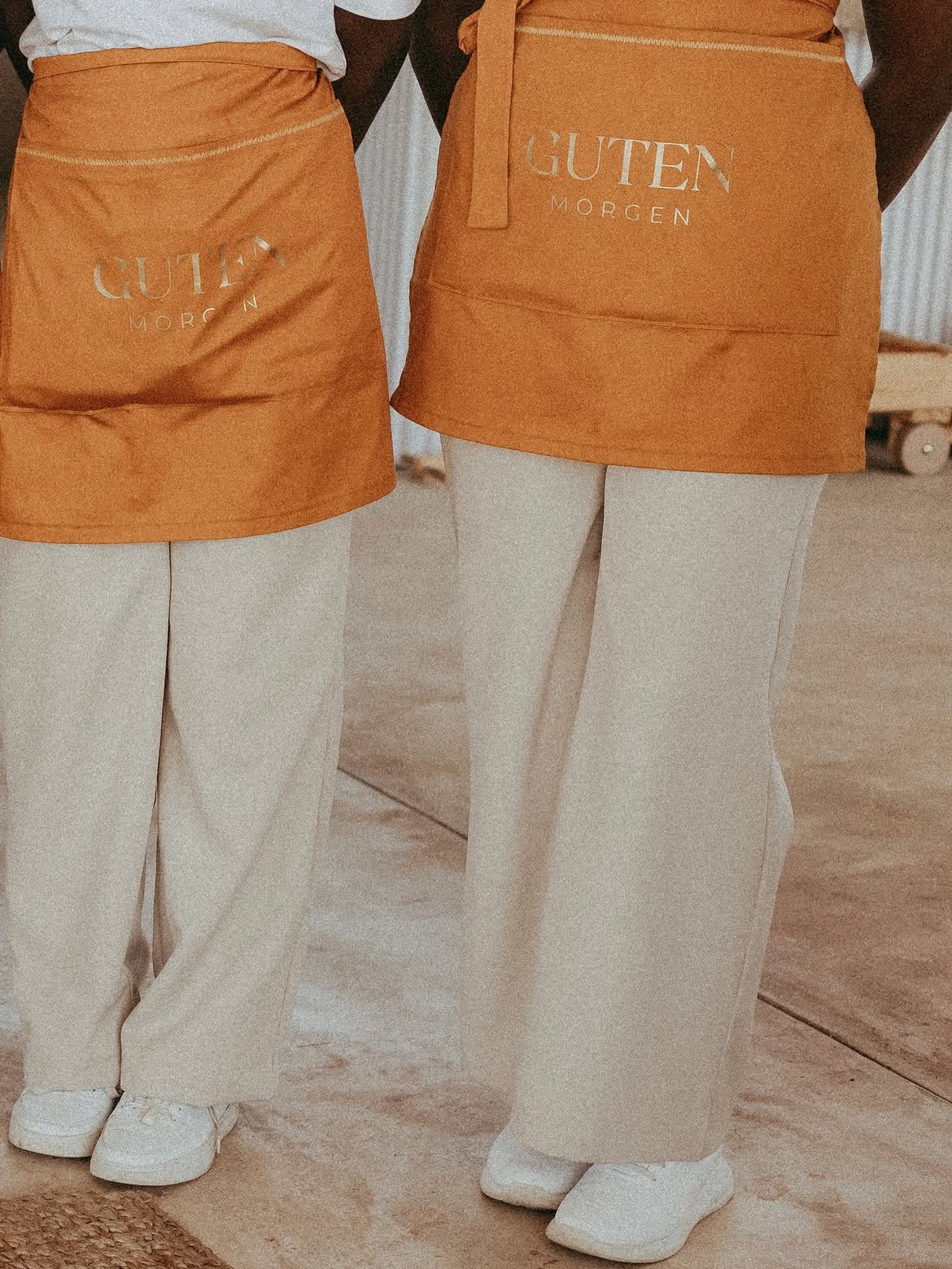 Guten Morgen staff wearing branded ochre aprons