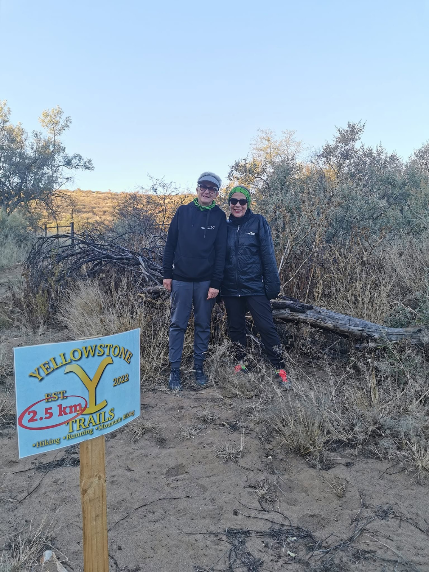 Two hikers beside the Yellowstone Trails 2.5 km marker sign