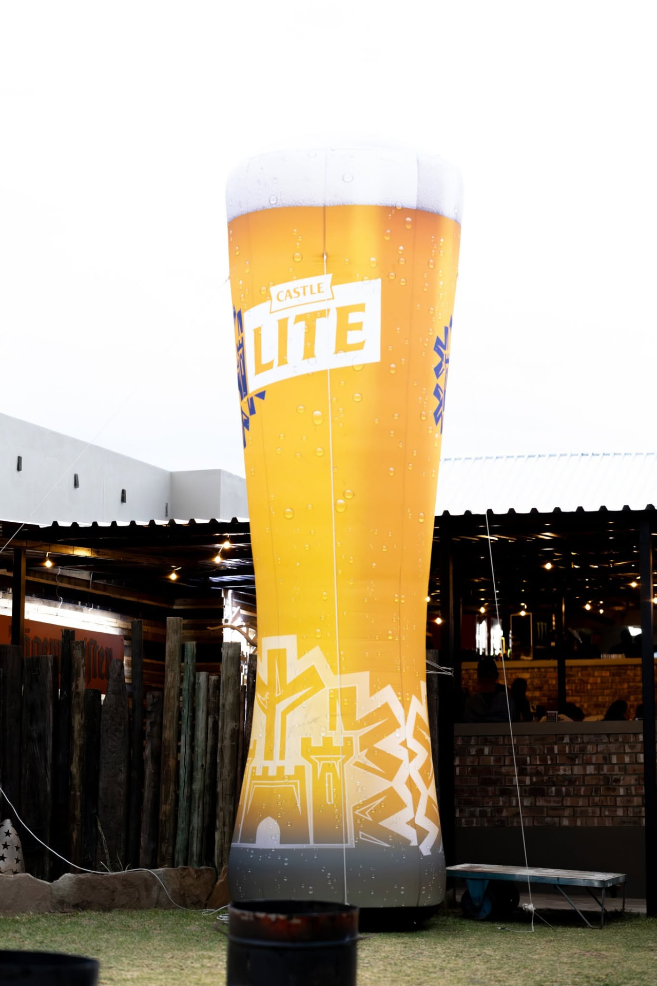 Giant inflatable beer glass standing outside the pub at dusk
