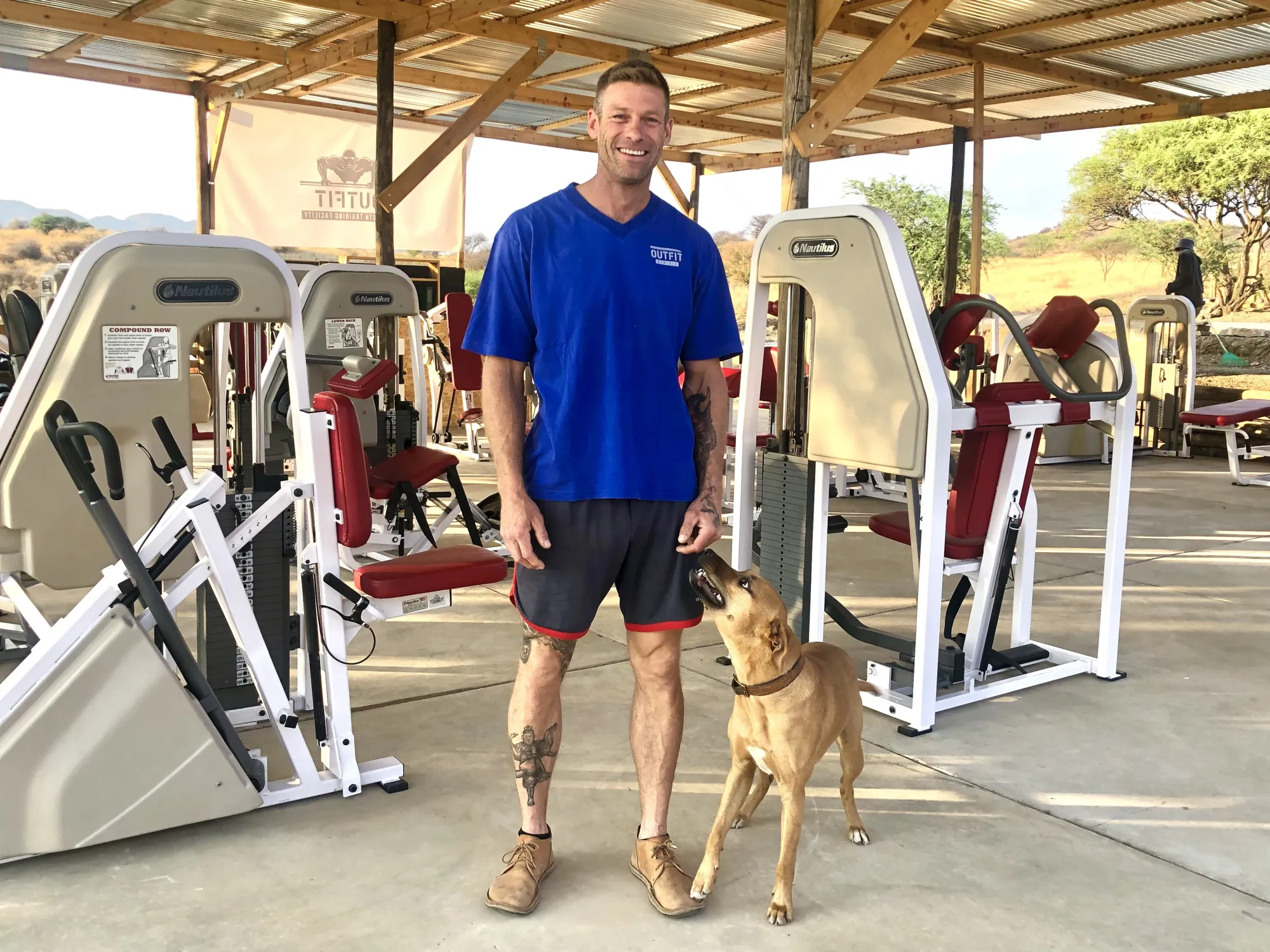 Rowan standing among the Nautilus machines in the covered Outfit Namibia gym