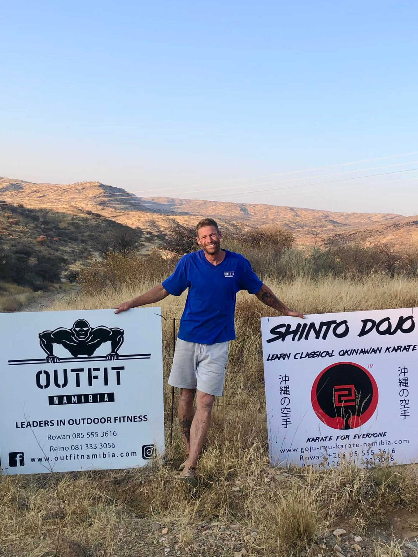 Outfit Namibia and Shinto Dojo signboards on the hillside