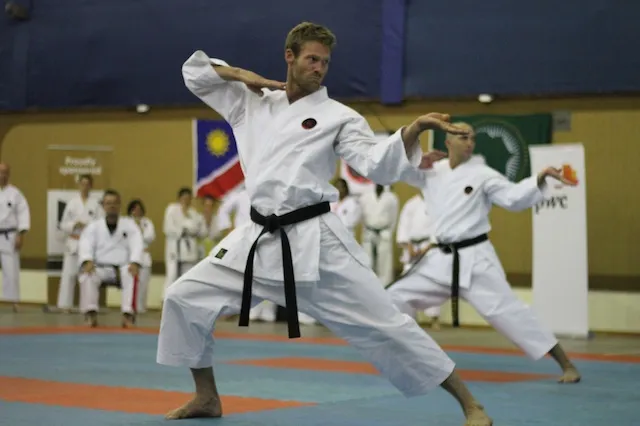 Rowan Carstens performing a Goju-Ryu kata in a black belt at a karate championship
