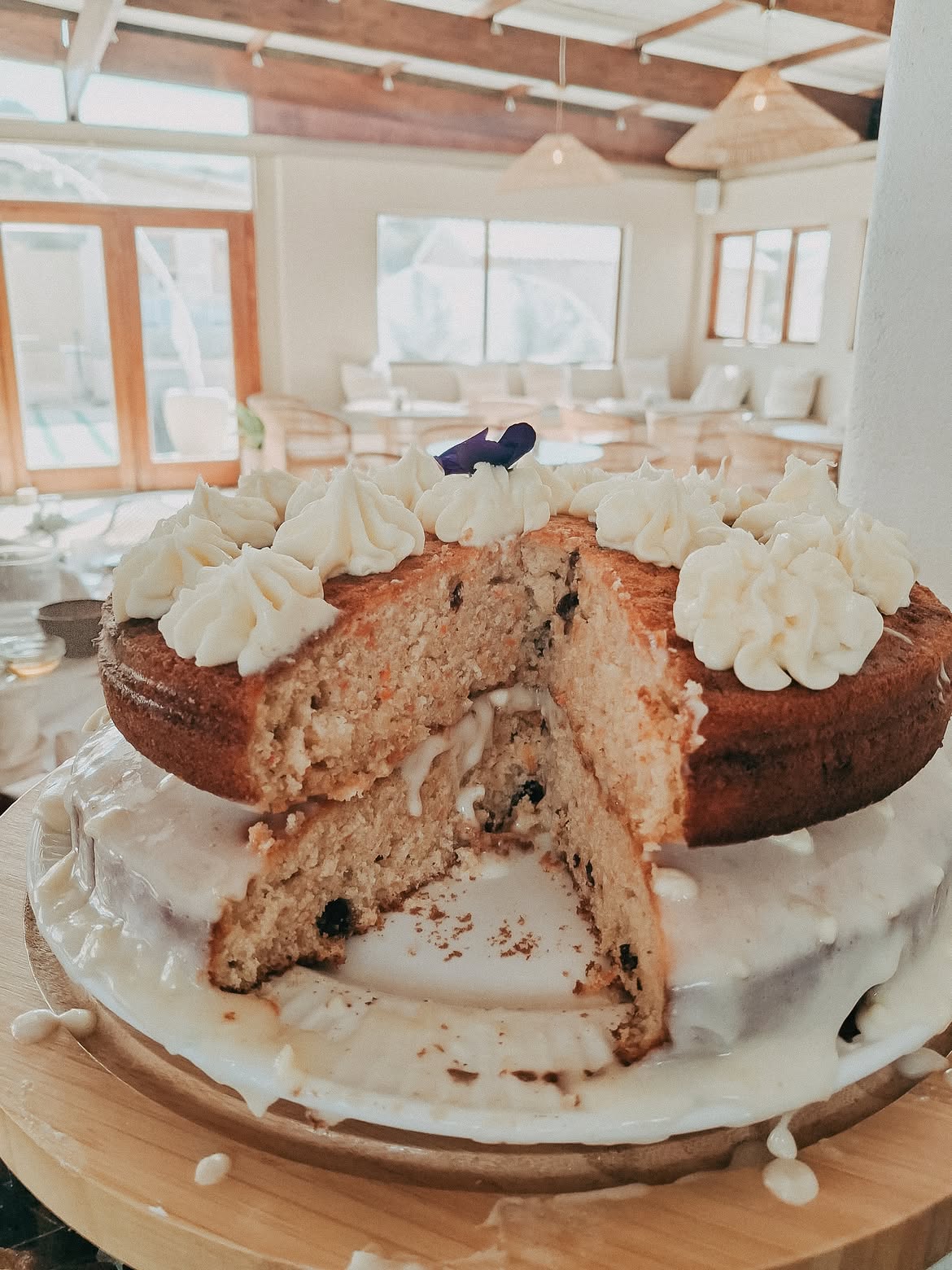 Homemade carrot cake with cream cheese frosting on a cake stand