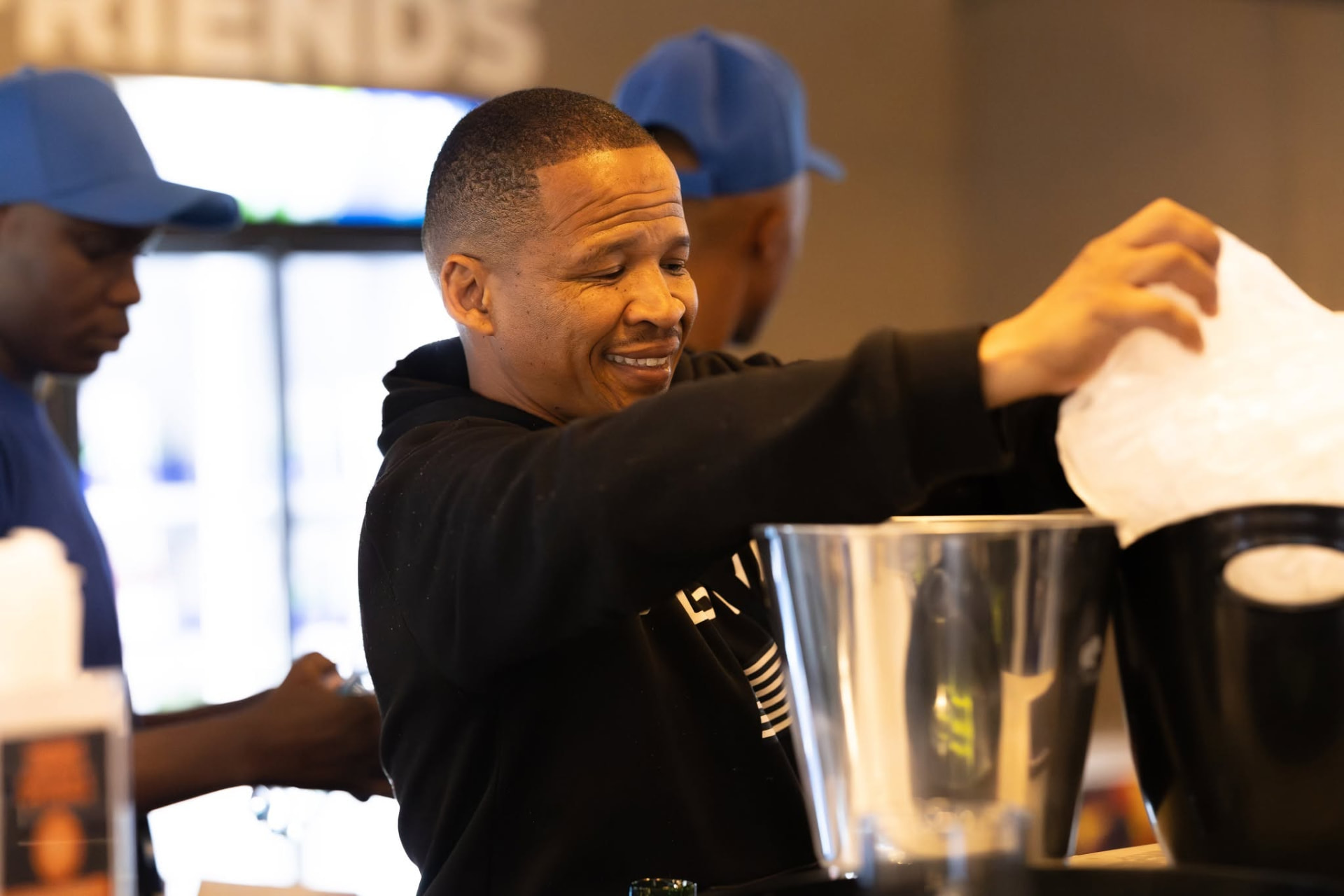 Bar team packing ice into buckets during service